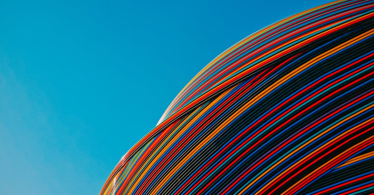 Vibrant striped architectural pavilion under a clear blue sky in Dubai. Modern design.