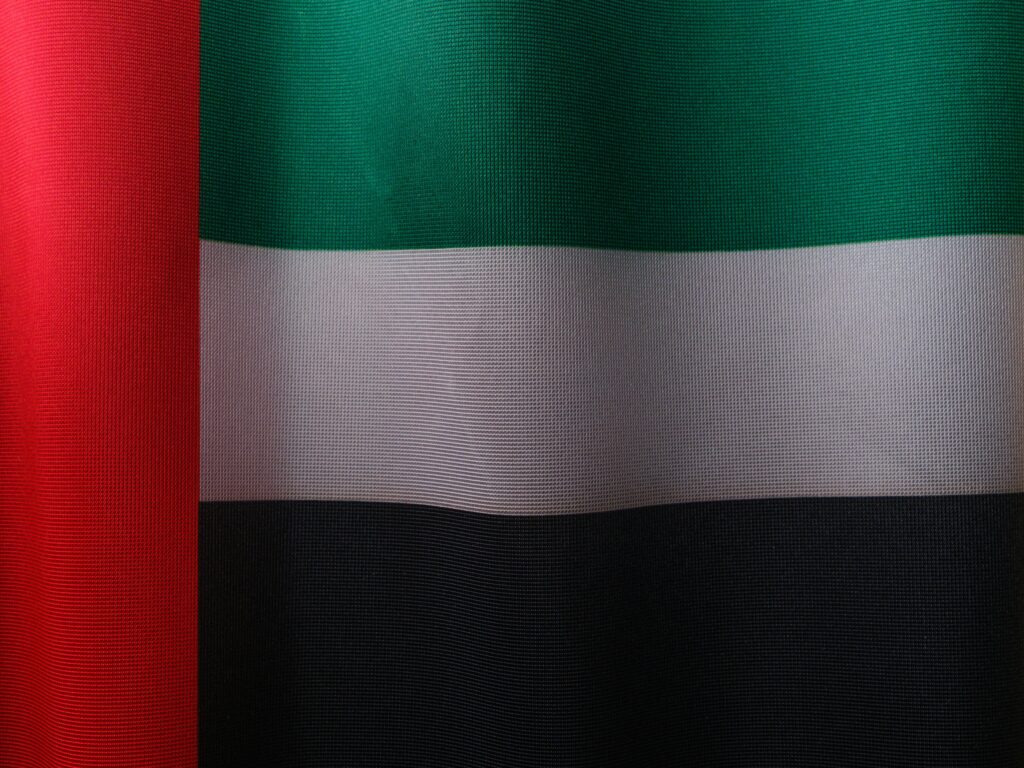 Detailed close-up of the United Arab Emirates flag with vibrant colors and fabric texture.